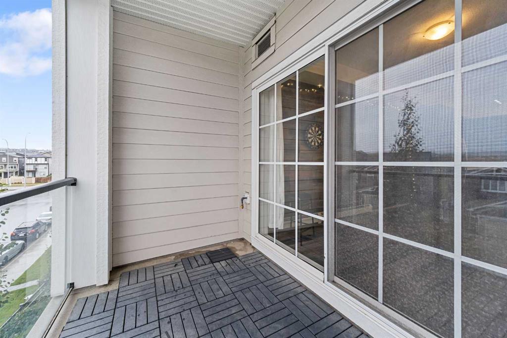 Balcony space with sliding glass door and wood tile flooring in Sage Meadows Park condo