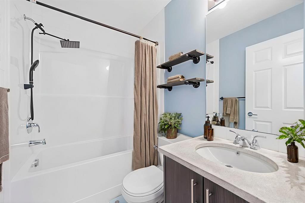Detached hallway bathroom with tiled floor and vanity.