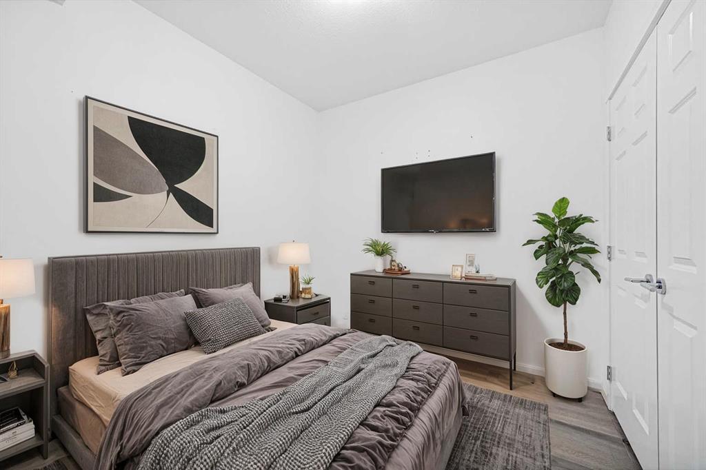Second bedroom with neutral decor and window light in Sage Meadows Park Calgary condo