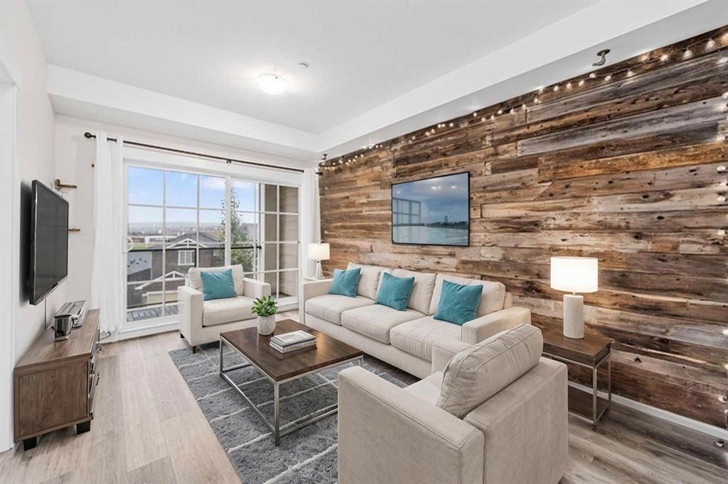 Living room with rustic wood feature wall, sofa set and large window balcony access