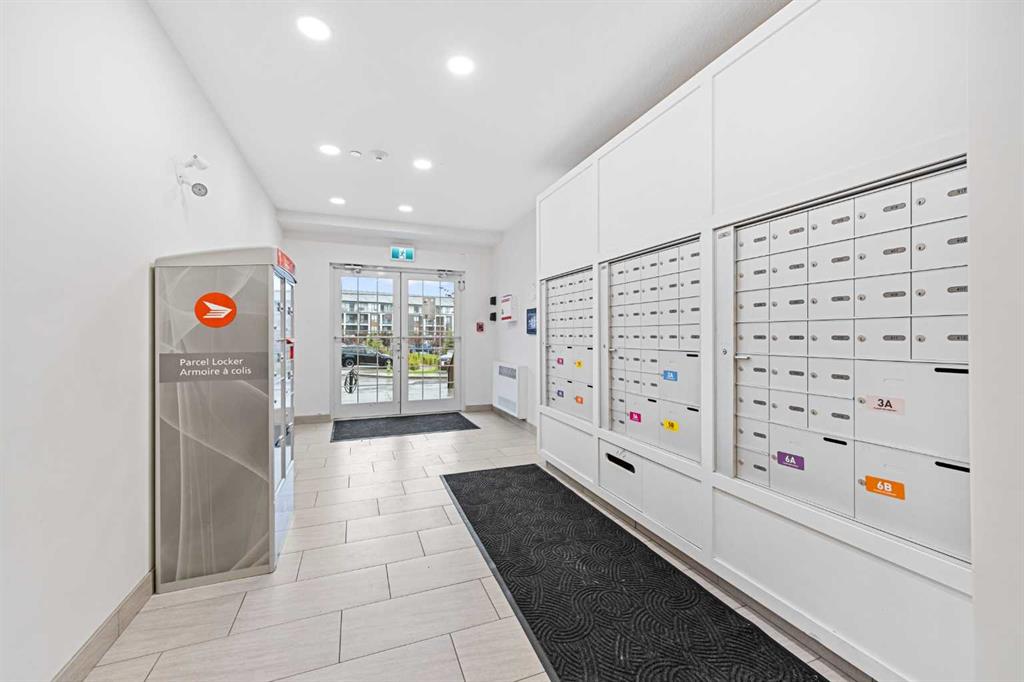 Mailroom with parcel lockers and mailboxes inside Sage Meadows Park condo building